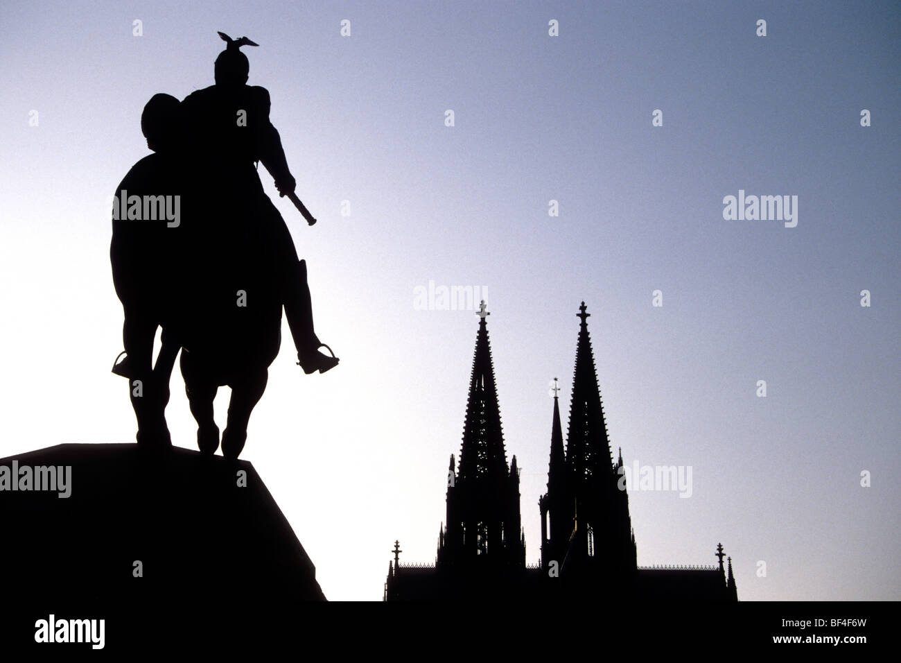 Equestrian statue of Emperor Wilhelm II in backlight, in the back the Koelner Dom Cologne Cathedral, Cologne, North Rhine-Westp Stock Photo