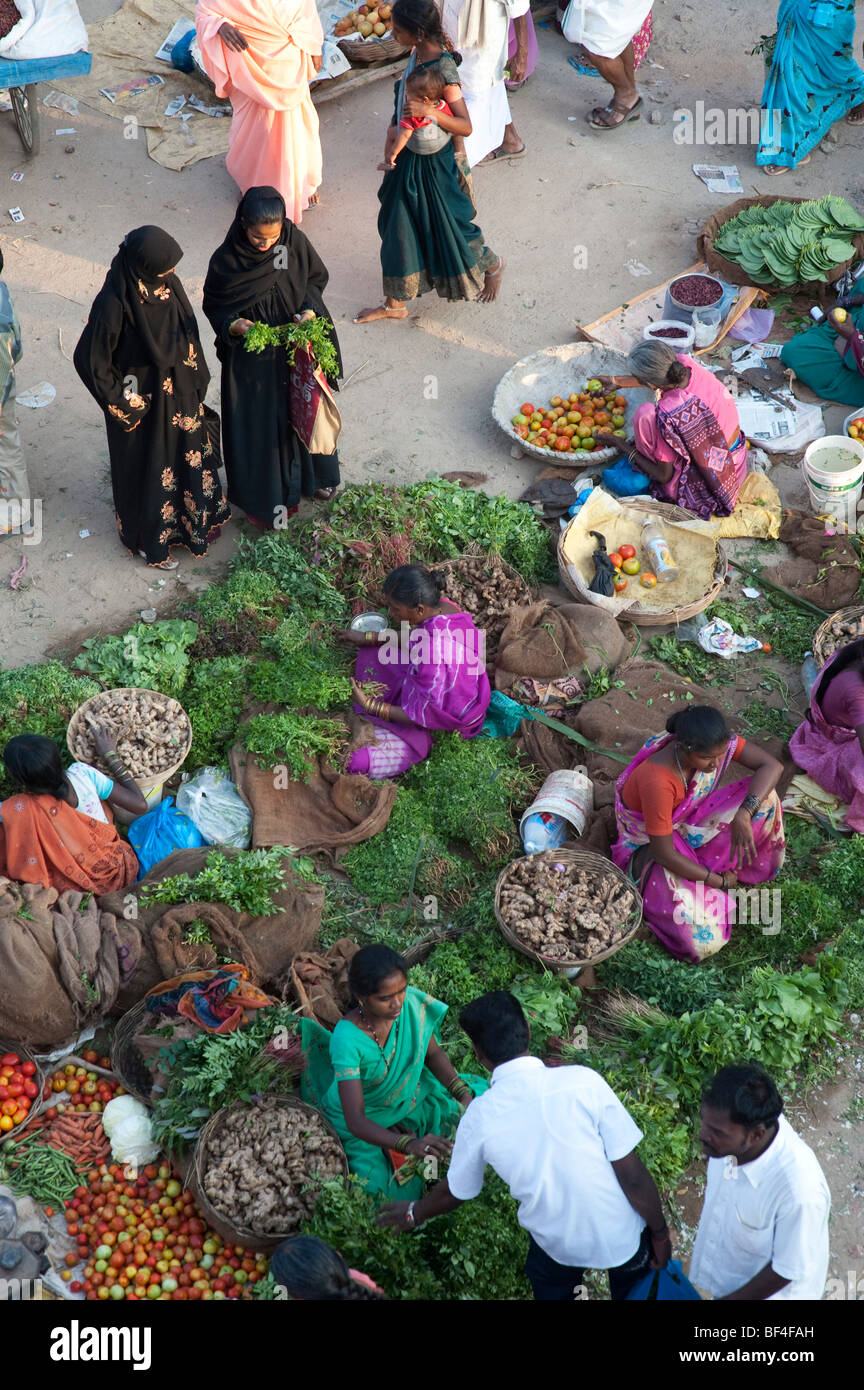 Muslim women buying from an Indian street vegetable market. Puttaparthi, Andhra Pradesh, India Stock Photo