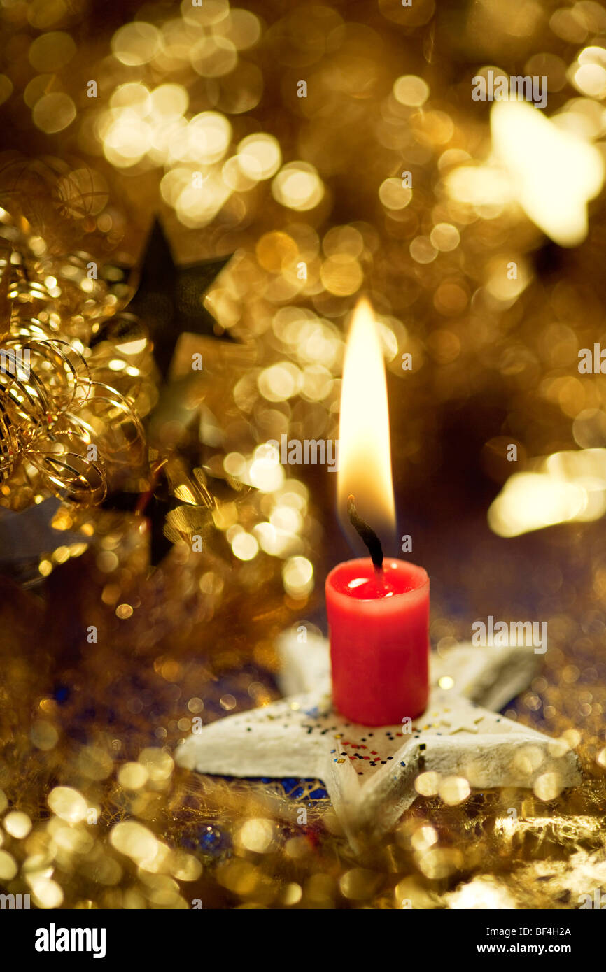 Christmas decorations with a burning red candle Stock Photo