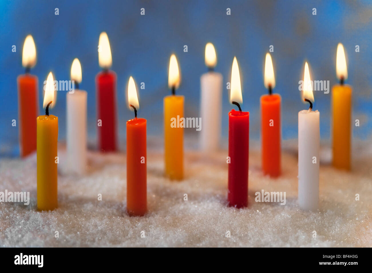 Burning coloured candles Stock Photo