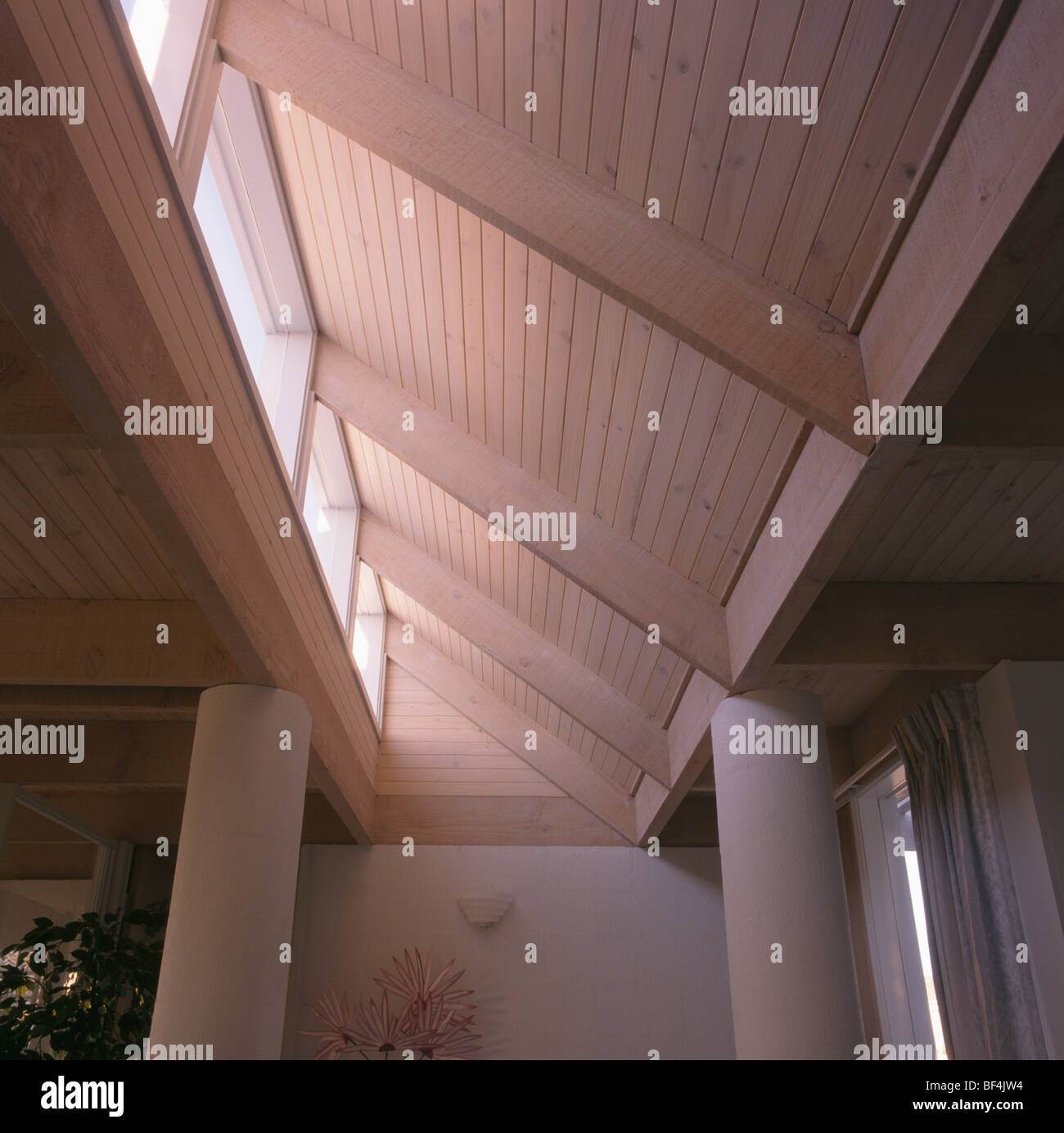 Looking up at sloping wooden ceiling in modern hall Stock Photo
