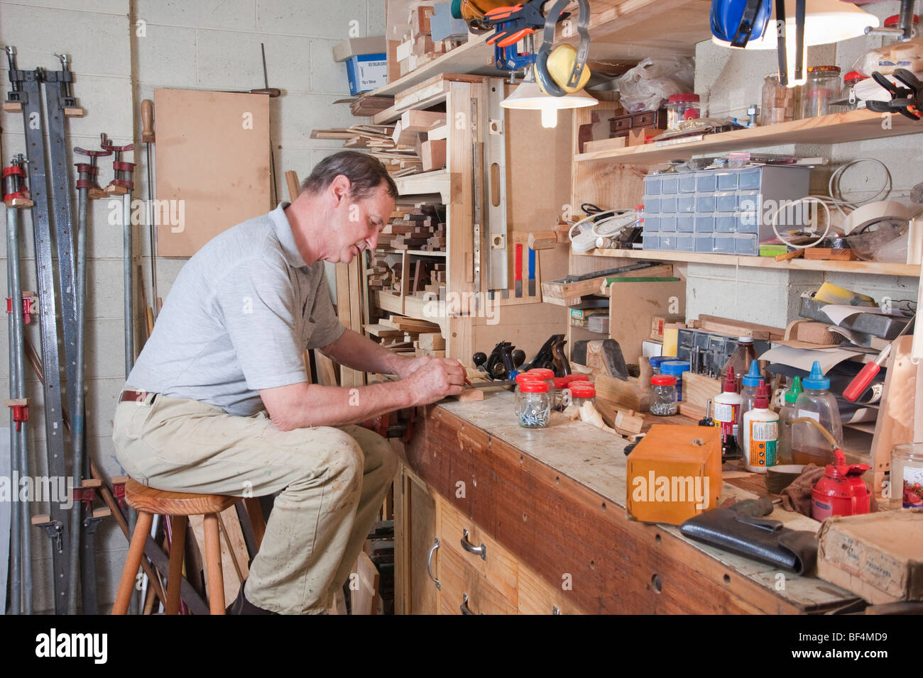 Older man at his workshop workbench Stock Photo