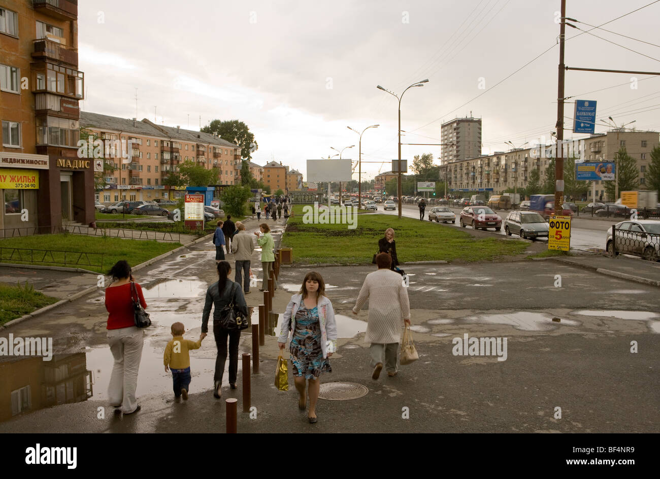 Pedestrians walking on pavement in city, Ekaterinburg, Uralmash, Russia Stock Photo