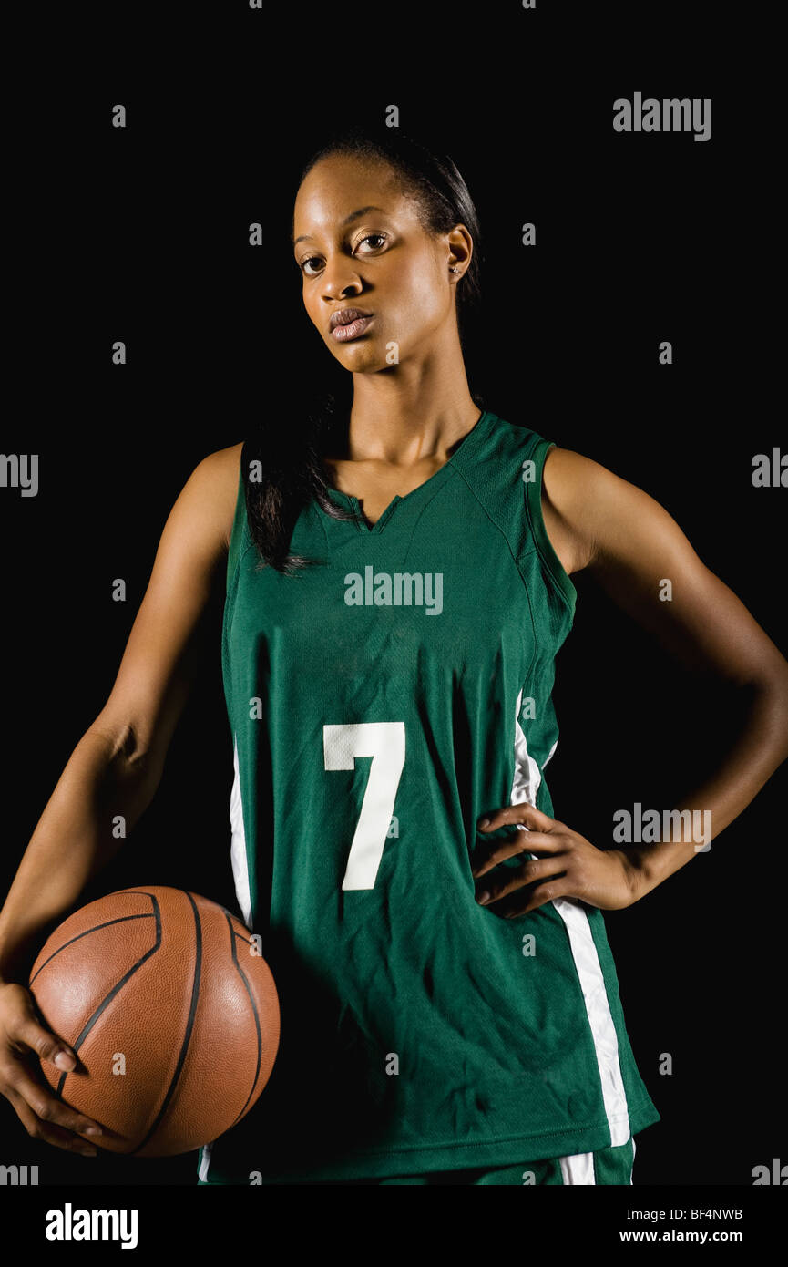 Mixed race basketball player holding basketball Stock Photo Alamy