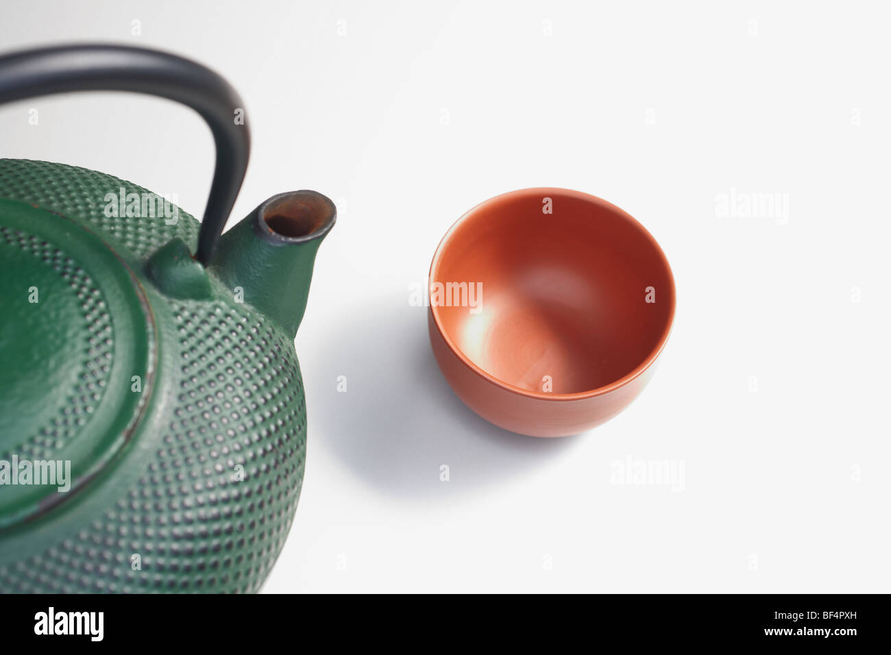 Cast iron teapot with a teacup Stock Photo