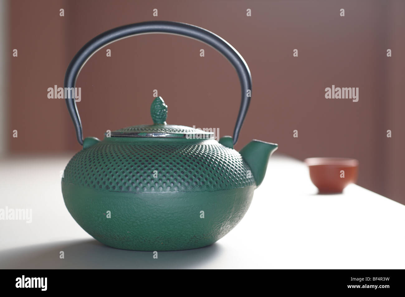 Cast iron teapot with a teacup Stock Photo