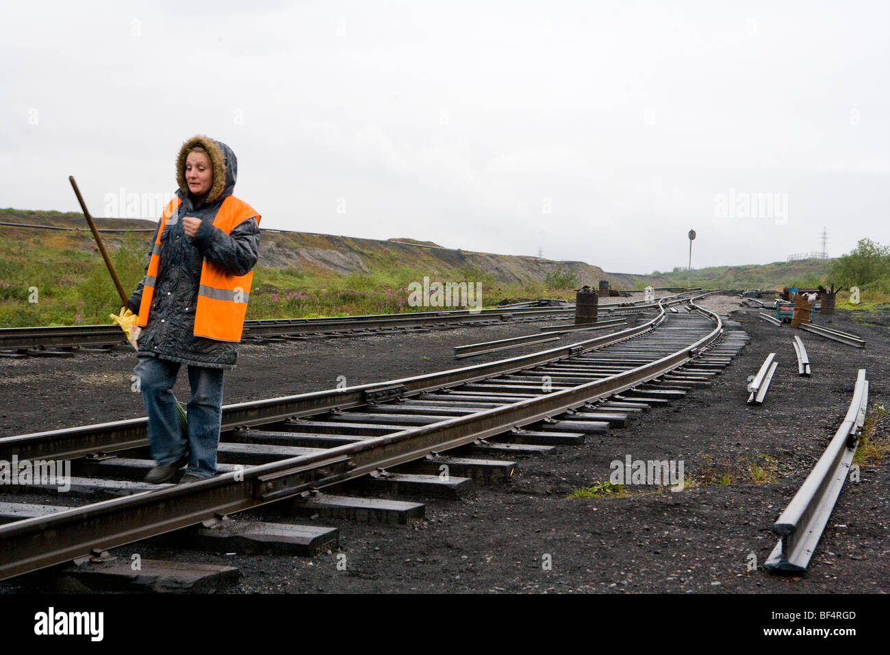 Woman railway worker on railway track in coal mining area, Vorkuta, Komi Republic, Arctic Russia Stock Photo