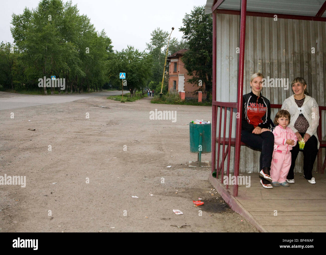 Women and child waiting in village bus shelter, portrait,  Urals, Russia Stock Photo