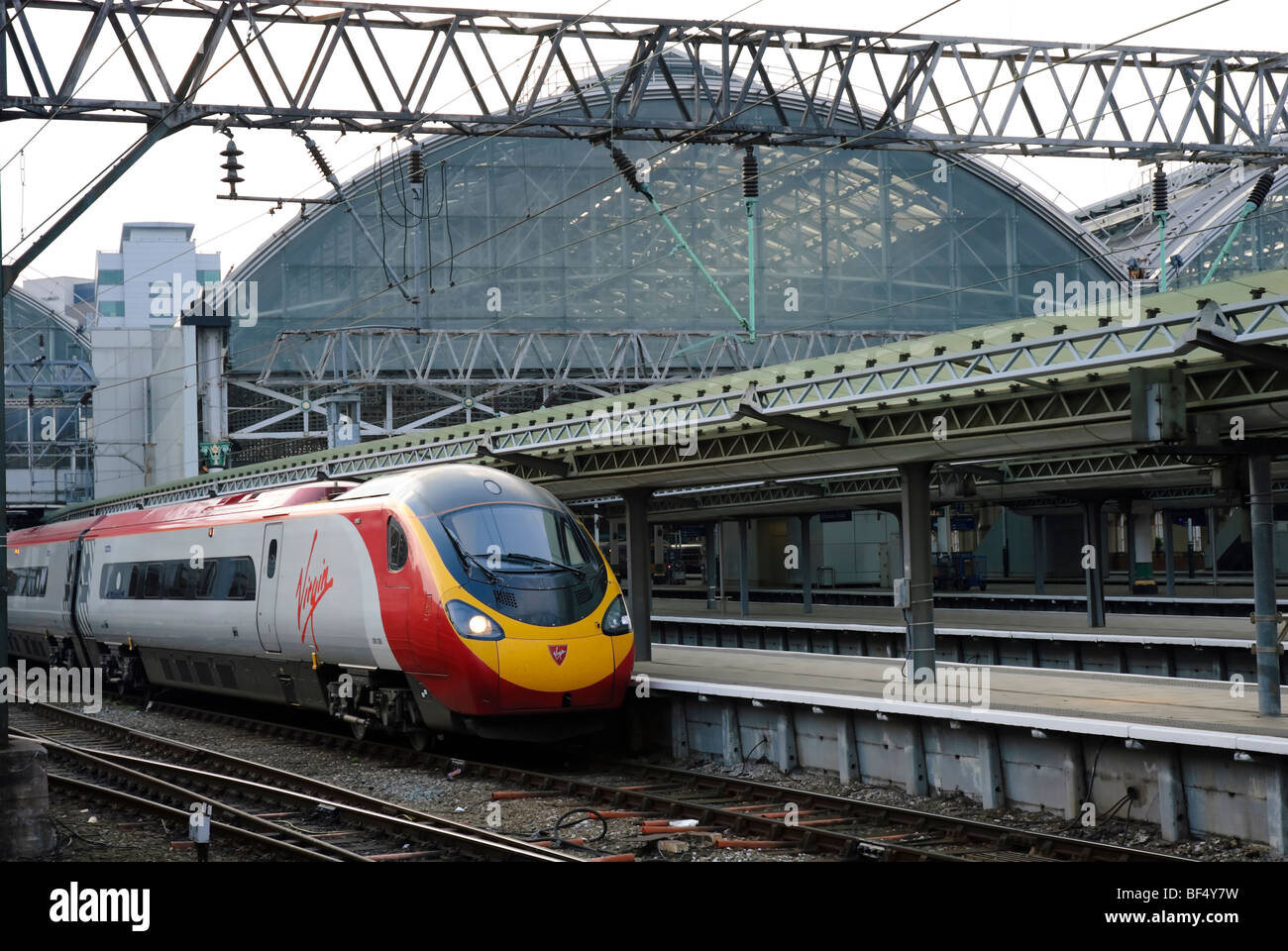 Intercity express train at a station. Virgin Trains Pendolino Express train at Manchester Piccadilly Station. Fast train. Electric power. Railway. Stock Photo