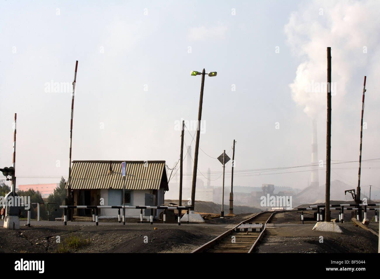 Railway track leading to copper smelting works smoke stacks, Karabash, Urals, Russia Stock Photo