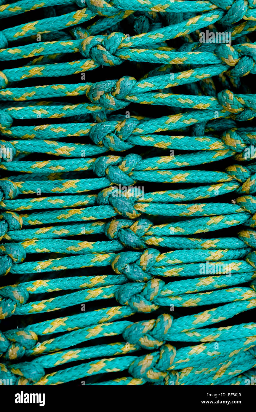 Industrial commercial green coloured fishing nets line the quayside in