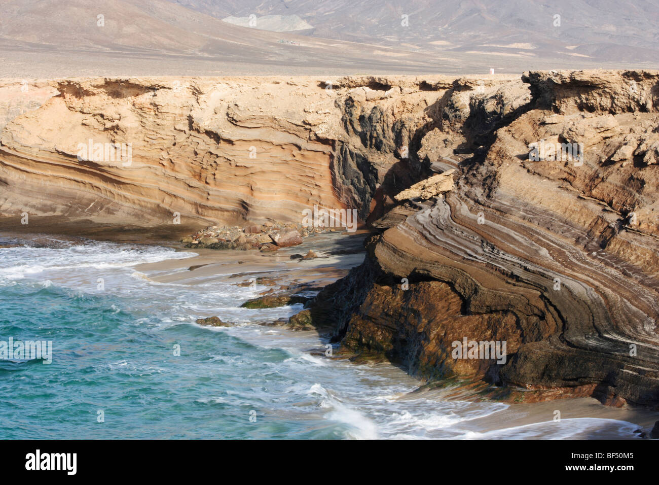 Layers of volcanic rock on cliffs on south coast of Fuerteventura in ...