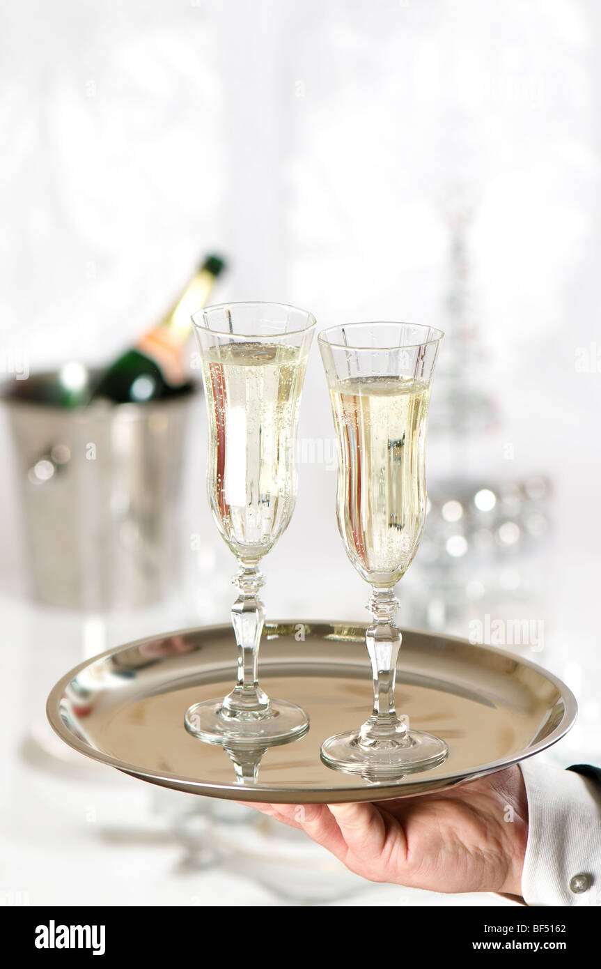 Waiter serving two glasses of champagne on a tray Stock Photo