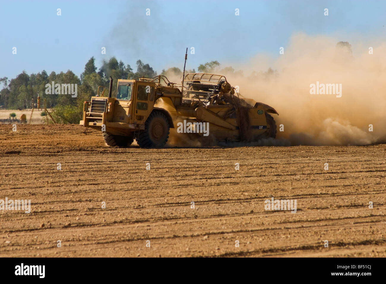 A land leveler prepares a field in preparation for the planting of a new almond orchard