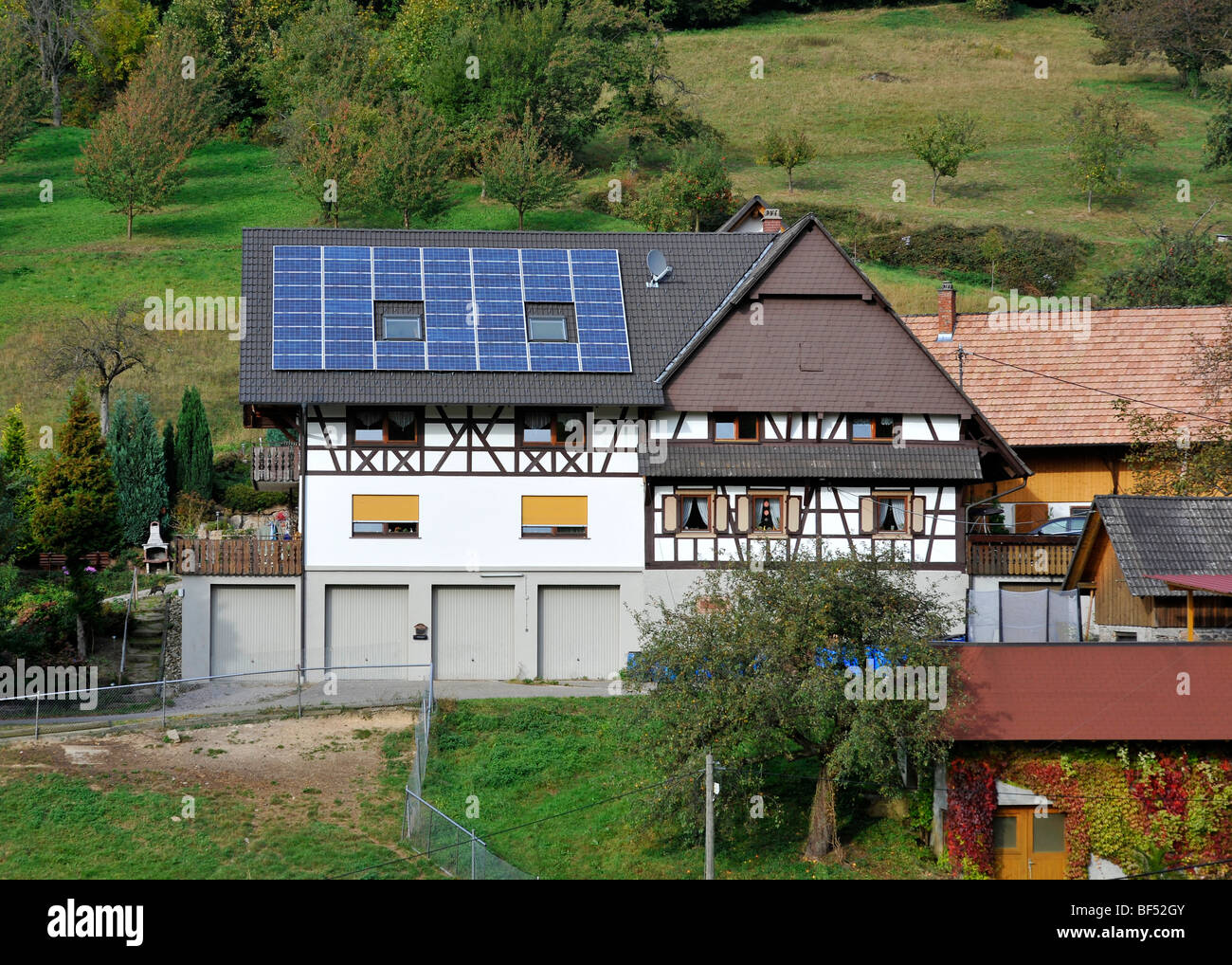 Solar panels on the roof of a house, farm, Gasthof Benz-Muehle inn, Ottenhoefen, Muehlenrundweg, Black Forest, Baden-Wuerttembe Stock Photo