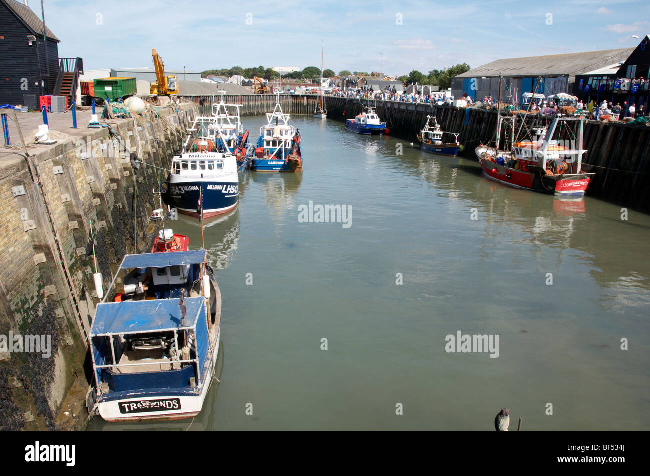 A view of Whitstable harbor with some fishing boats Stock Photo
