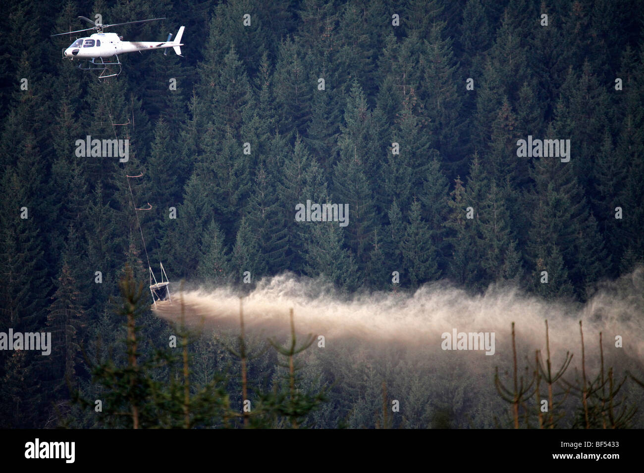 To prevent acidification of the forest floor, the forest is sprayed with lime by helicopter, Oberhof, Thuringia, Germany, Europe Stock Photo