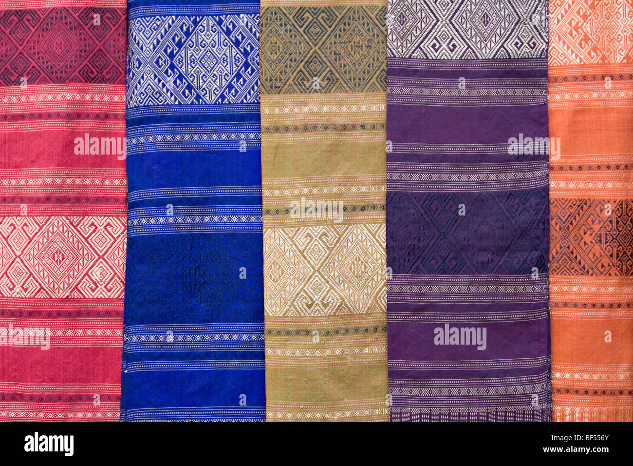 Colourful silk textiles on display at a market stall in Luang Prabang, Laos Stock Photo