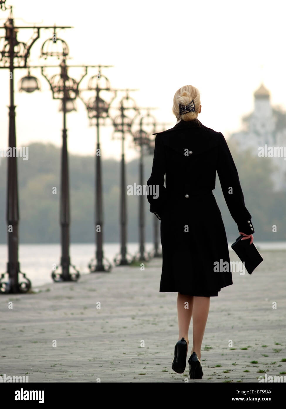 Woman coat walking rear view blond hi-res stock photography and images ...