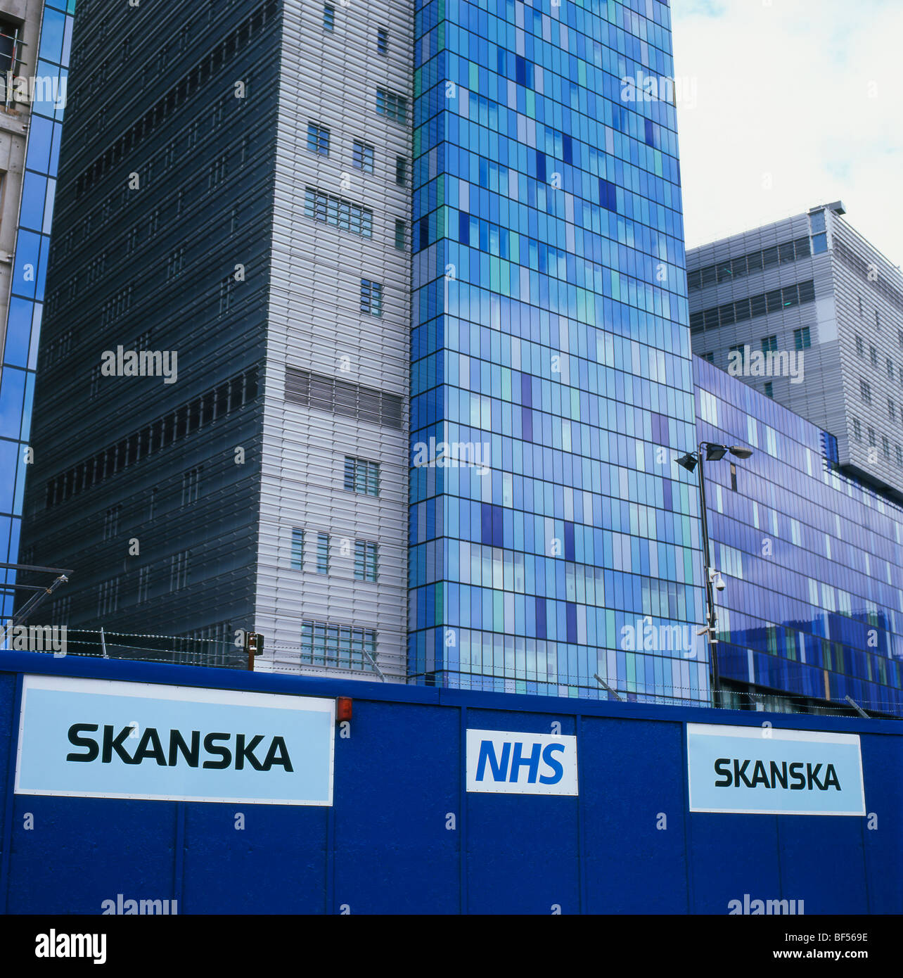 New buildings, Skanska and NHS signs exterior view of the Royal London Hospital in Whitechapel East London, UK   KATHY DEWITT Stock Photo