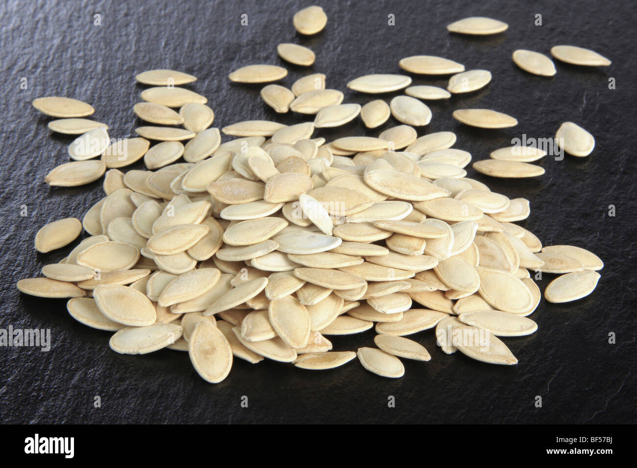 Pumpkin seeds (Cucurbita) on a slate Stock Photo Alamy