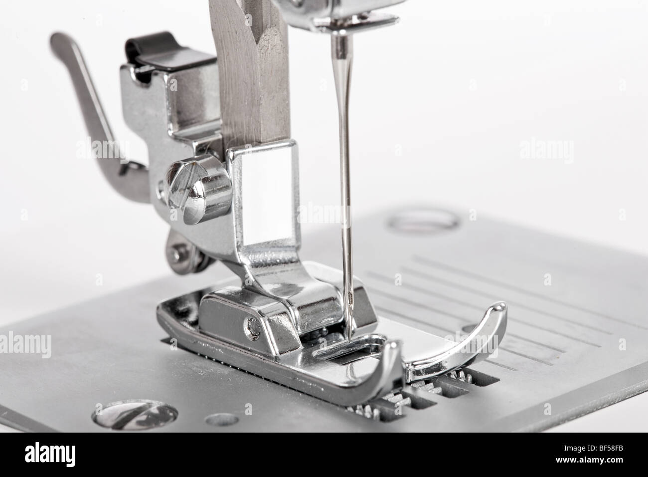 Needle plate, foot and transporter of a sewing machine Stock Photo