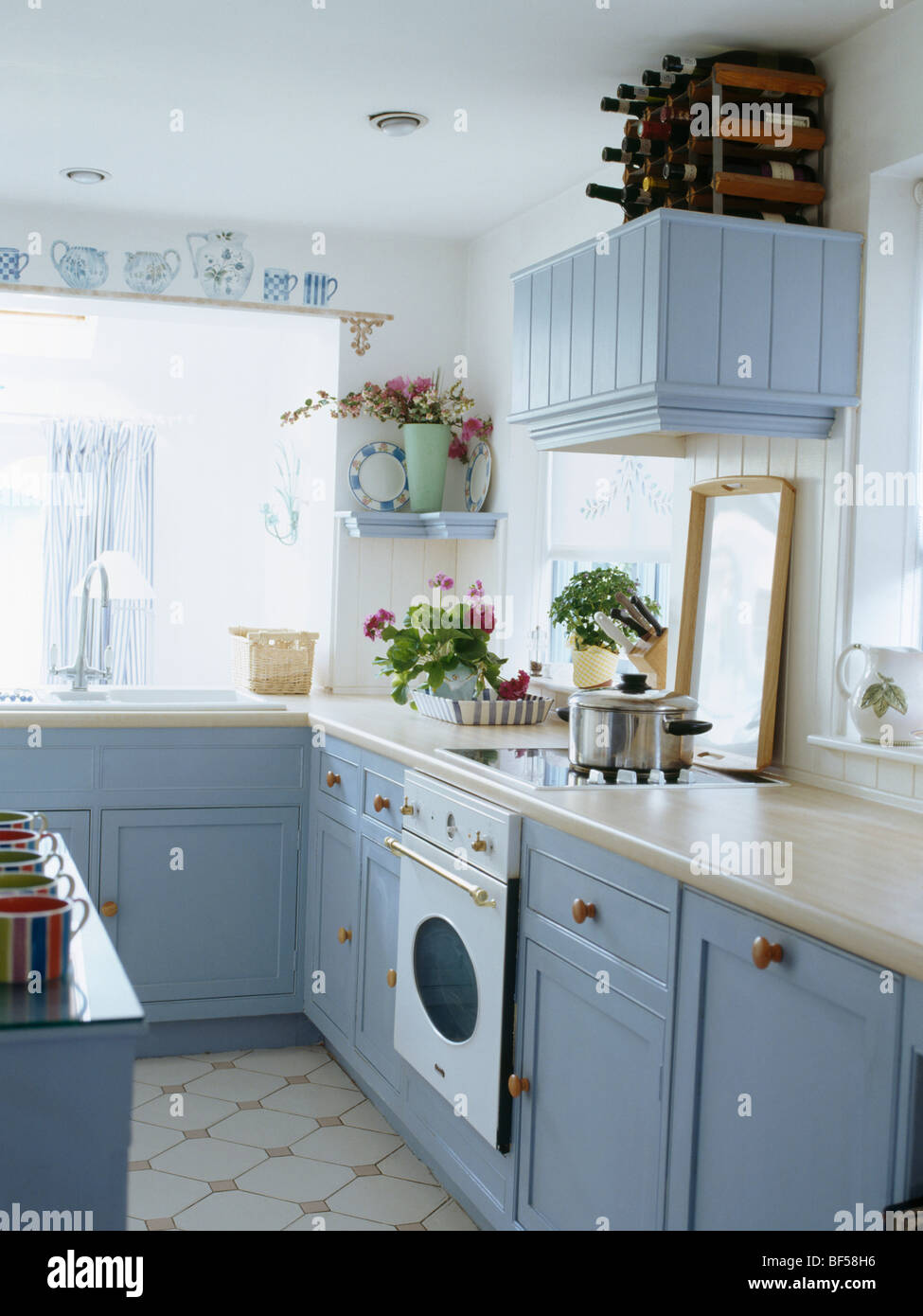 White cottage kitchen with pastel blue fitted cupboards and units and