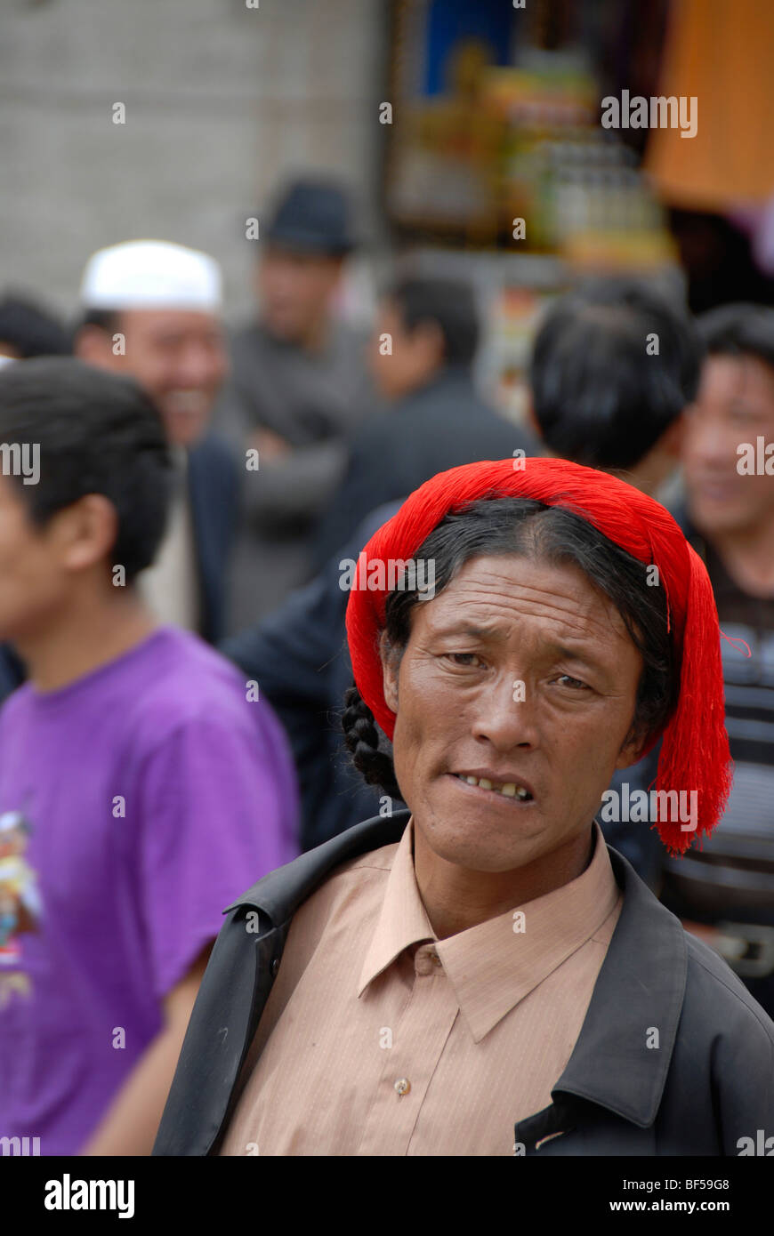 Portrait, Tibetan woman wearing a red hair band, historic town centre of Lhasa, Himalayas, Tibet Autonomous Region, People's Re Stock Photo
