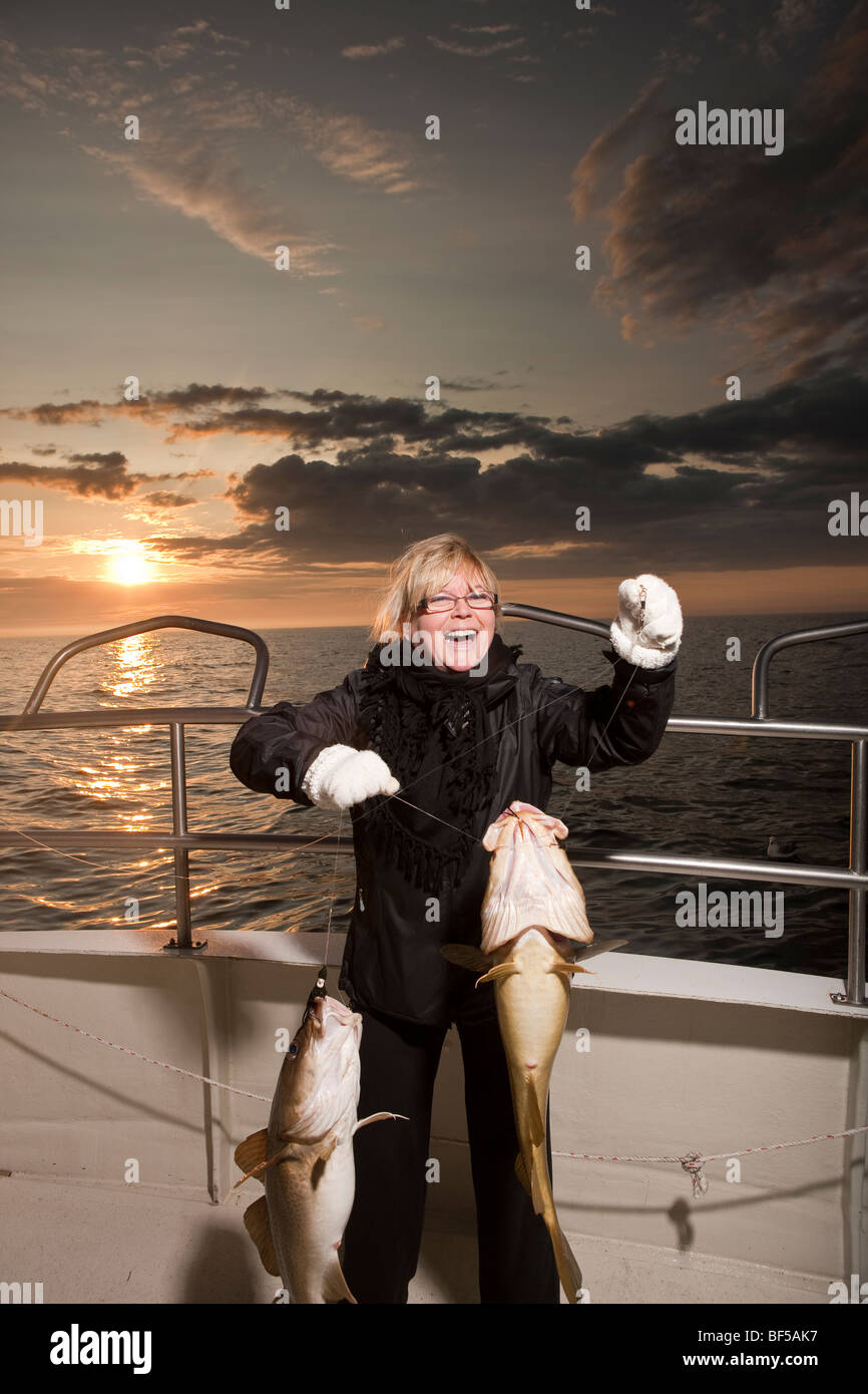 Woman with Freshly caught cod, North Atlantic, Raufarhofn, Iceland Stock Photo