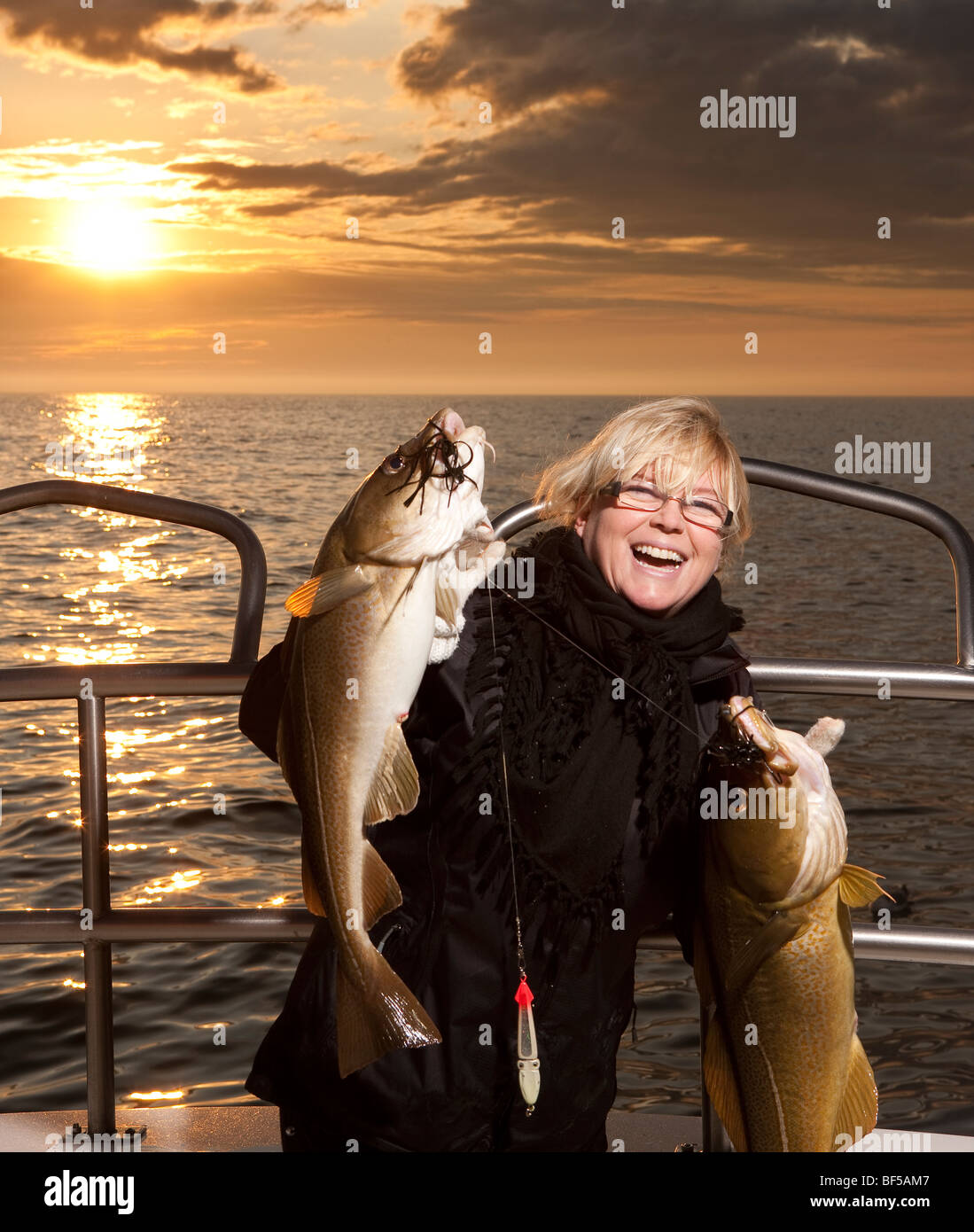 Woman with freshly caught cod, North Atlantic, Raufarhofn, Iceland Stock Photo