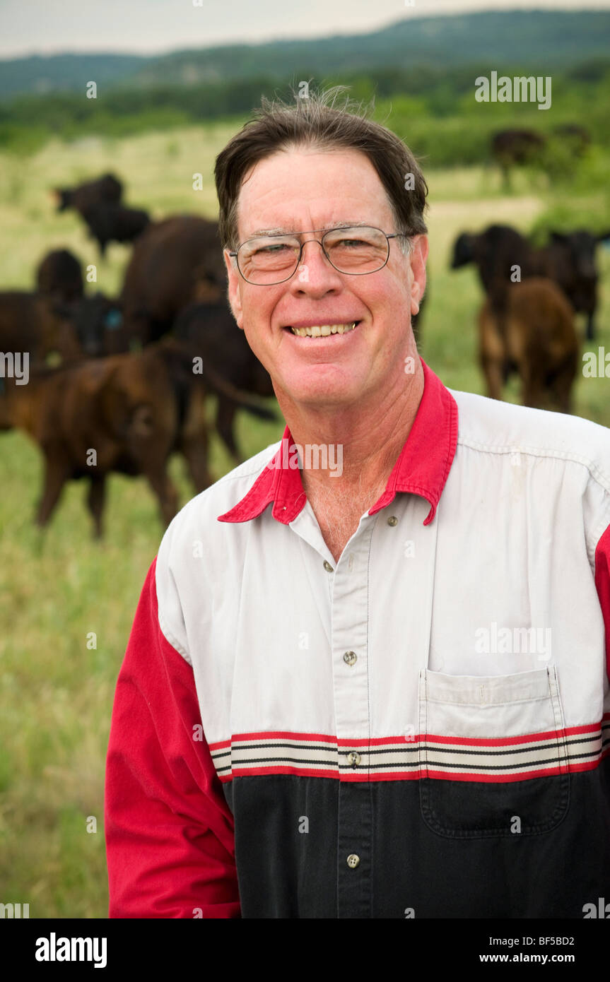 Mike Campsey, a beef producer and rancher poses on a pasture with