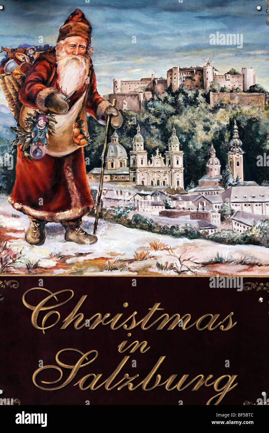 Santa Claus in front of a panoramic view of Salzburg, painted sign advertising a shop for Christmas decorations, Christmas, Jud Stock Photo