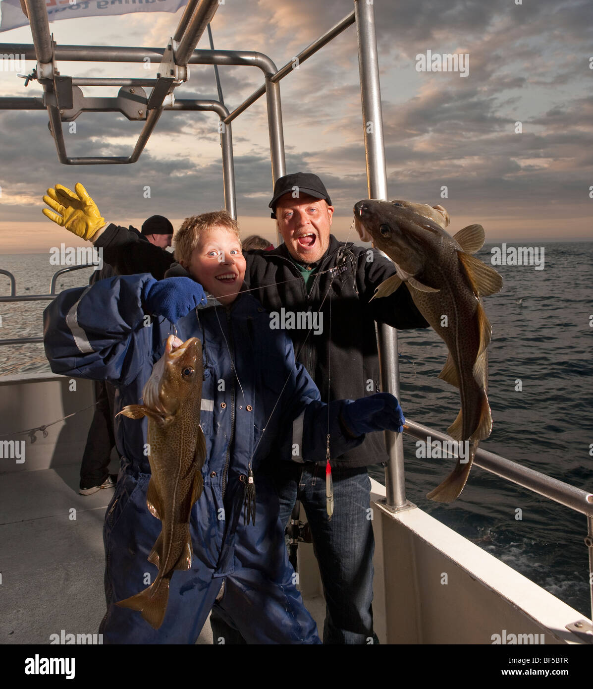 Father and son with cod fish, North Atlantic, Raufarhofn, Iceland Stock Photo