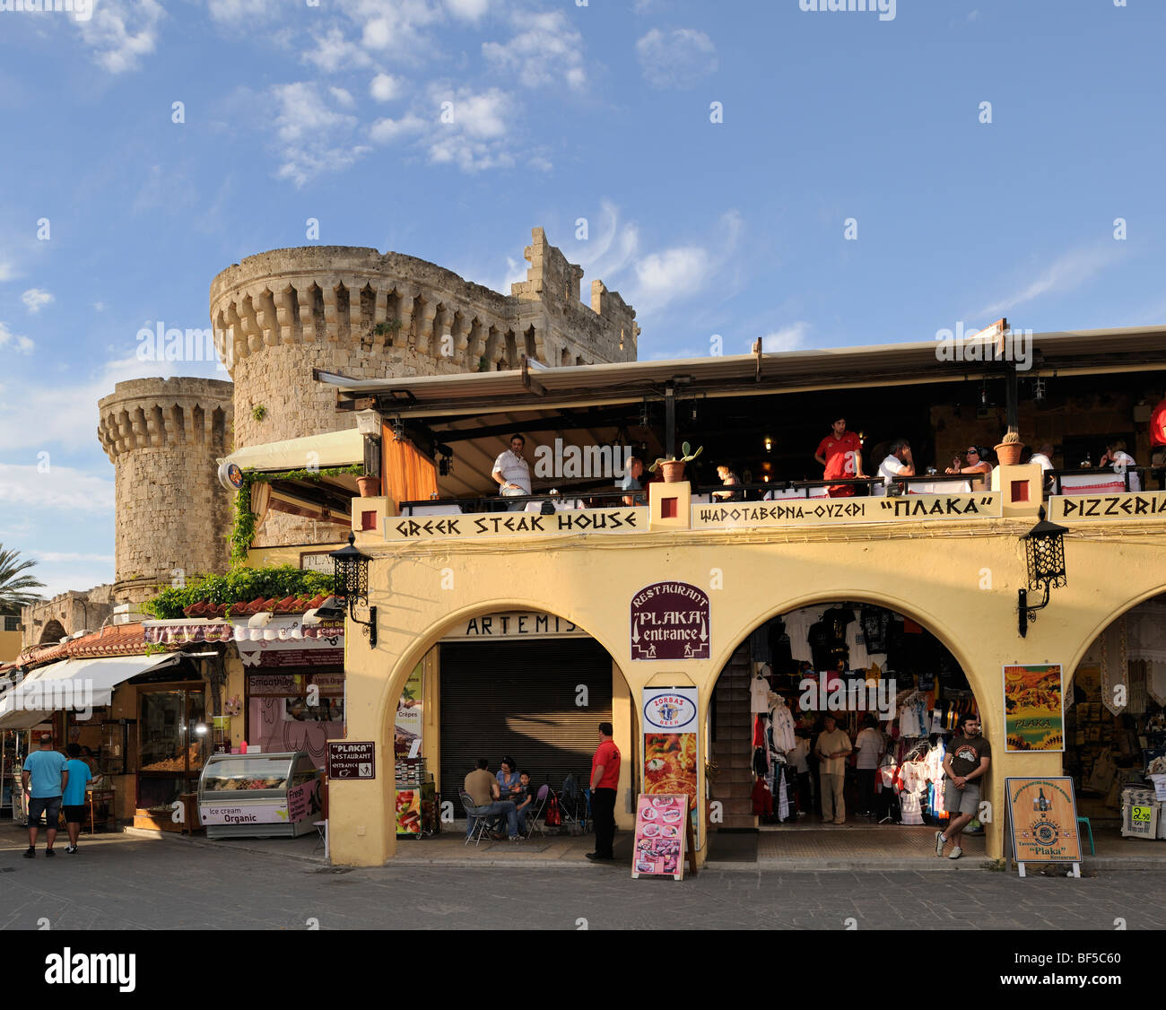 Restaurant and Thalassini gate seen from the Platia Ippokratou, Rhodes Town, Rhodes, Greece, Europe Stock Photo