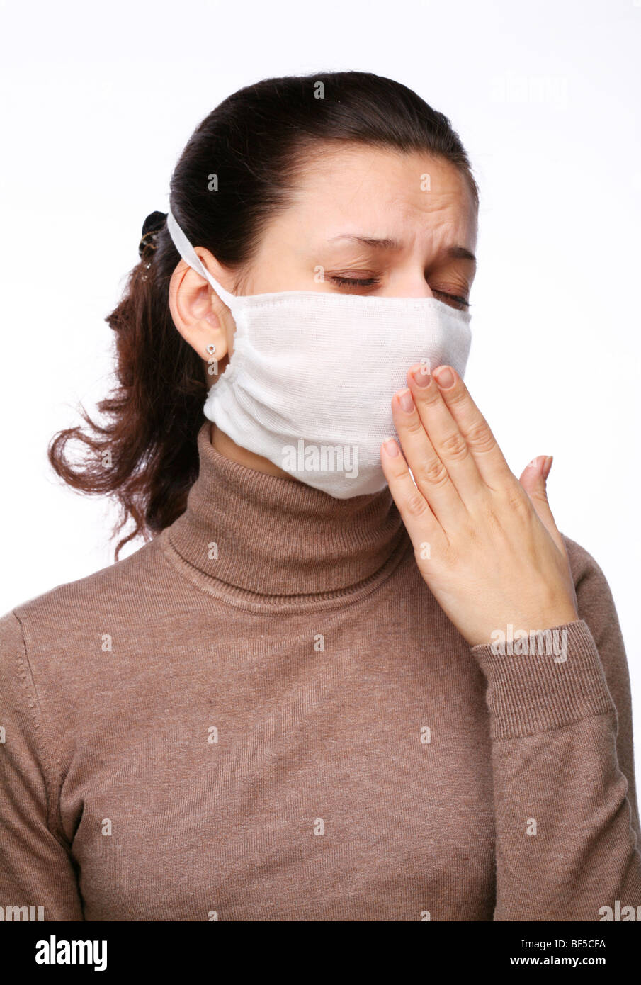 Coughing woman in a medical mask on a white background Stock Photo