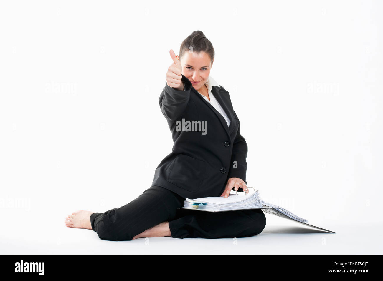 happy young businesswoman with files showing thumbs up Stock Photo