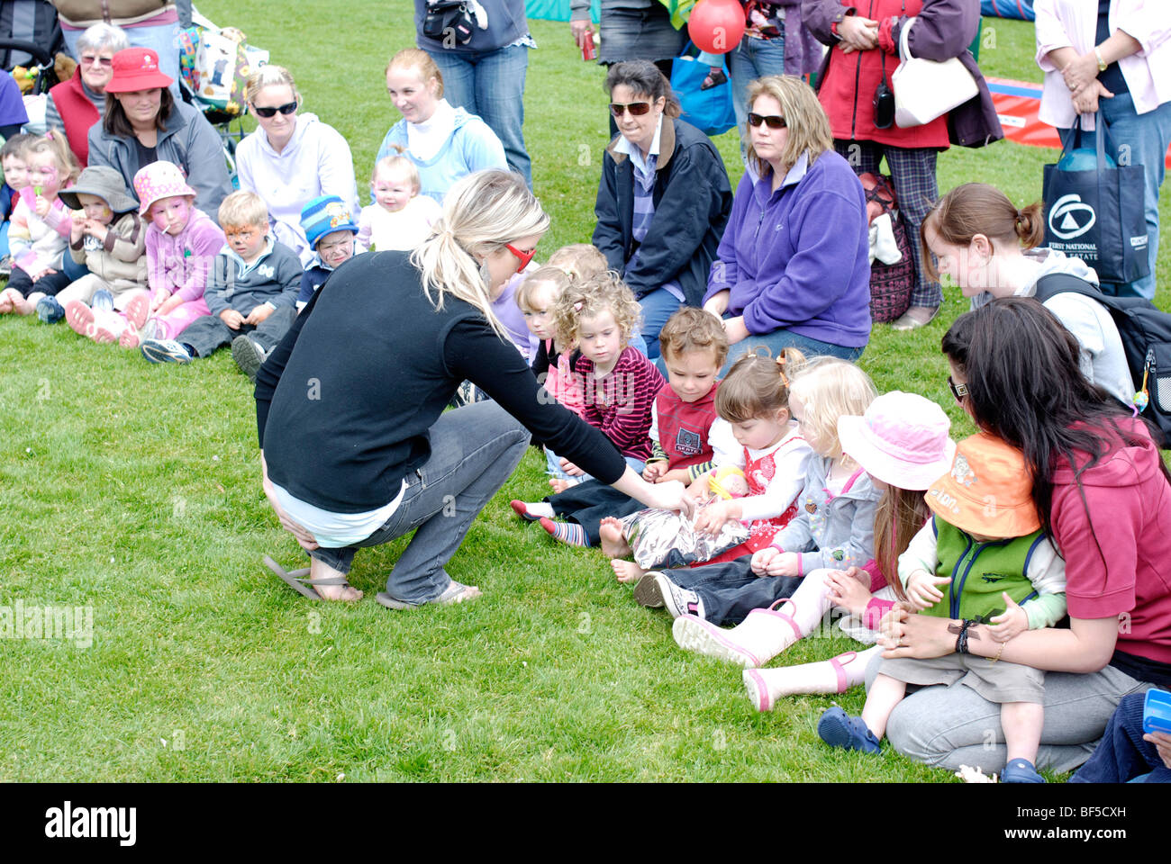Young children and parents at a community event. Stock Photo