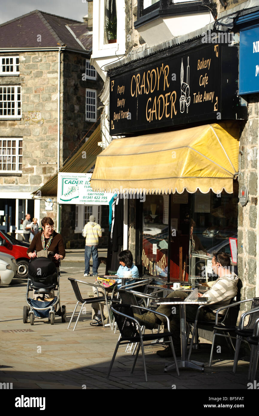 People sitting at tables outside cafe in Dolgellau town centre , Gwynedd, Snowdonia National Park, Wales UK Stock Photo