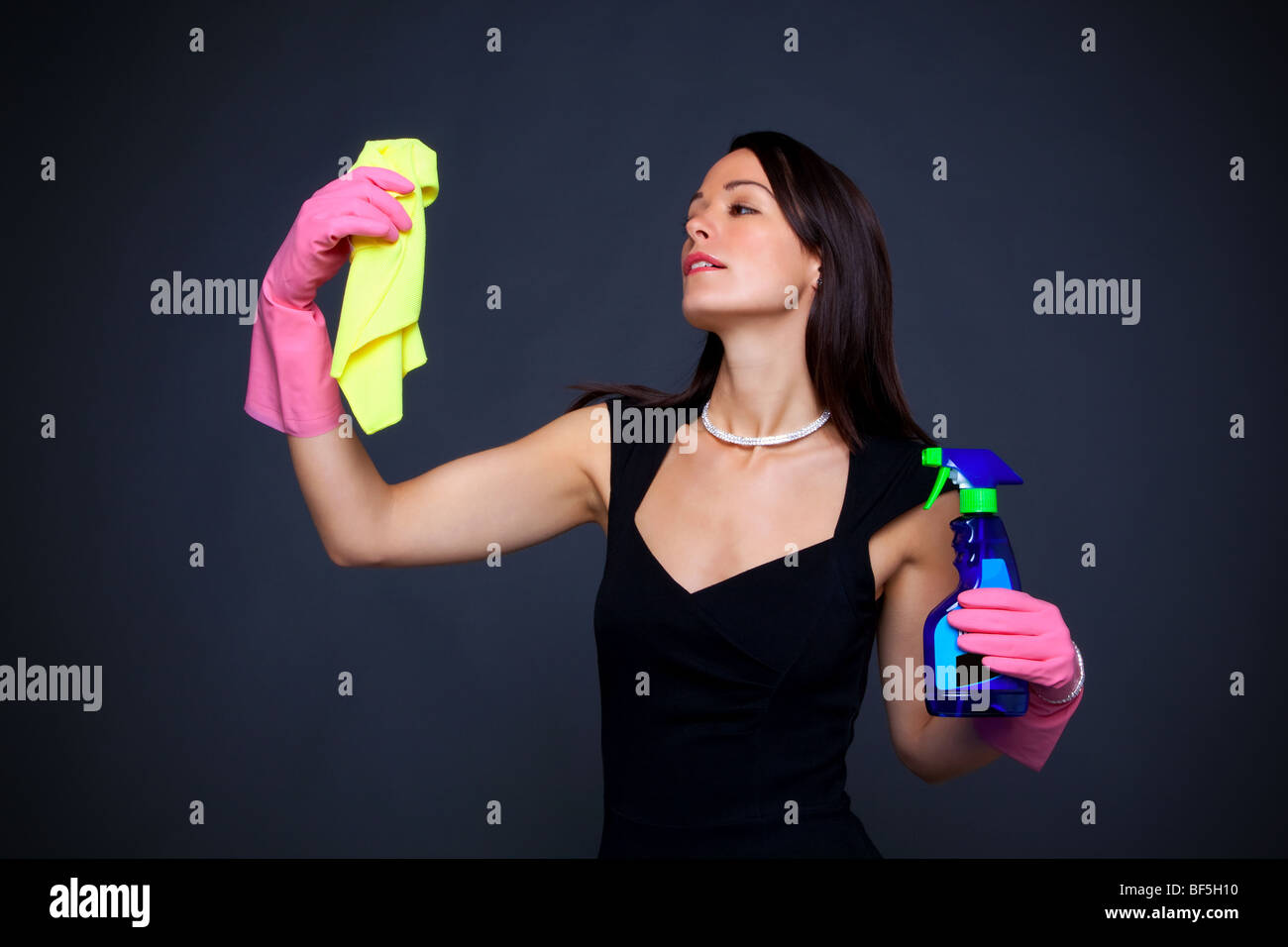 Abstract image of a glamorous housewife all dressed up to do the dusting. Stock Photo