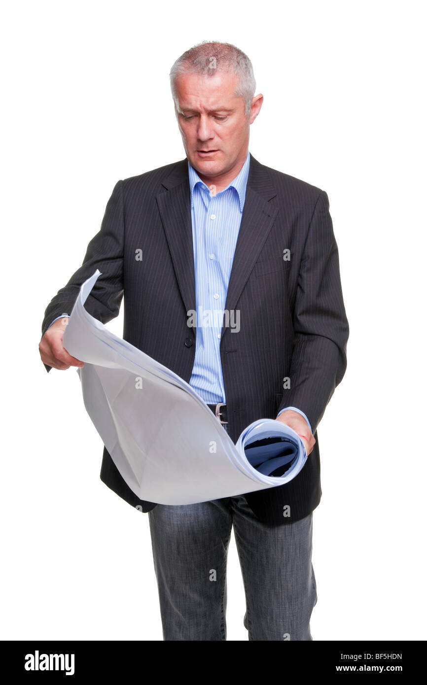 Male architect holding a set of building plans, isolated on a white background. Stock Photo