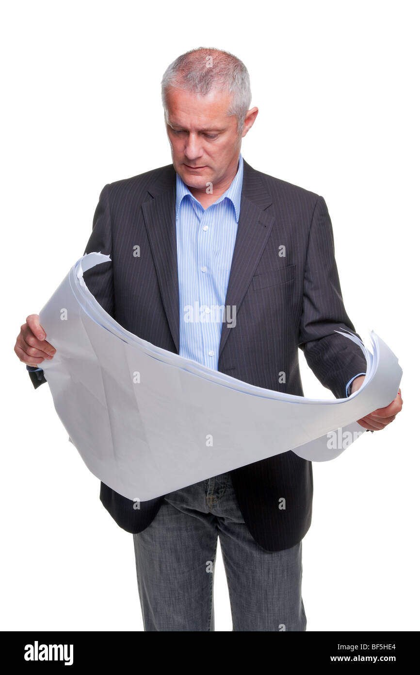Male architect holding a set of building plans, isolated on a white background. Stock Photo
