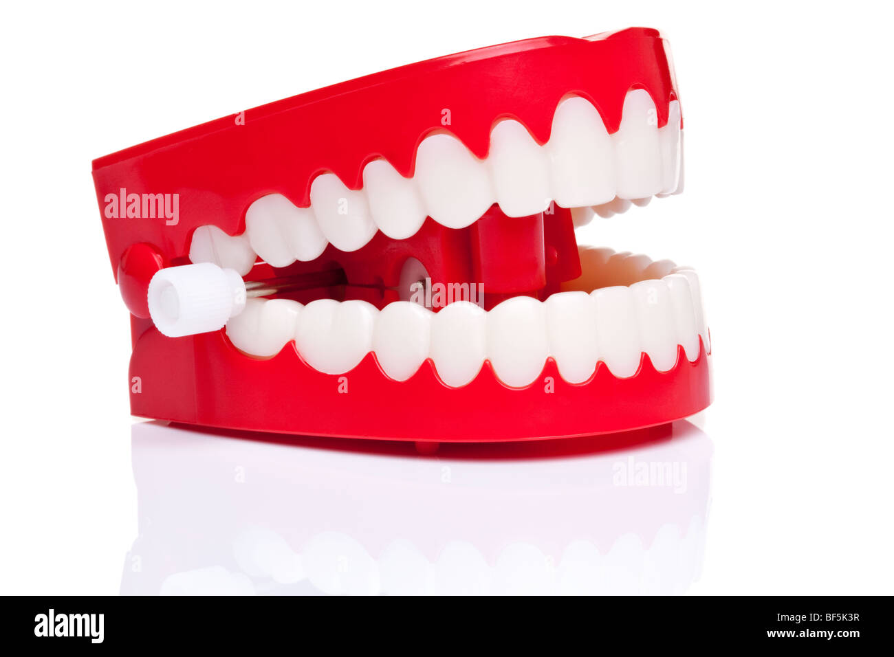 A pair of joke wind up chattering teeth on a pure white background, high resolution photo. Stock Photo