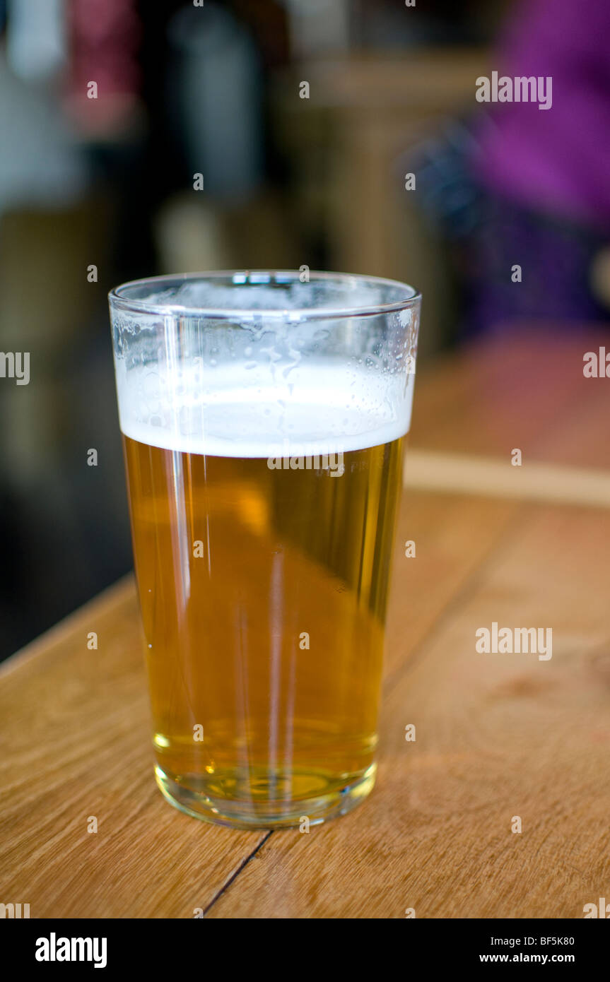 A pint of real pale ale on a table in a typical english pub Stock Photo