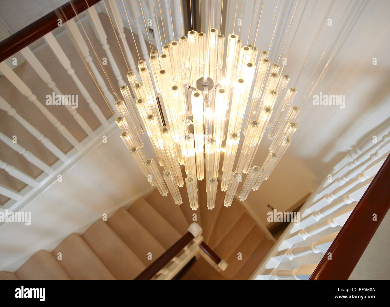 stairwell with modern chandelier Stock Photo - Alamy