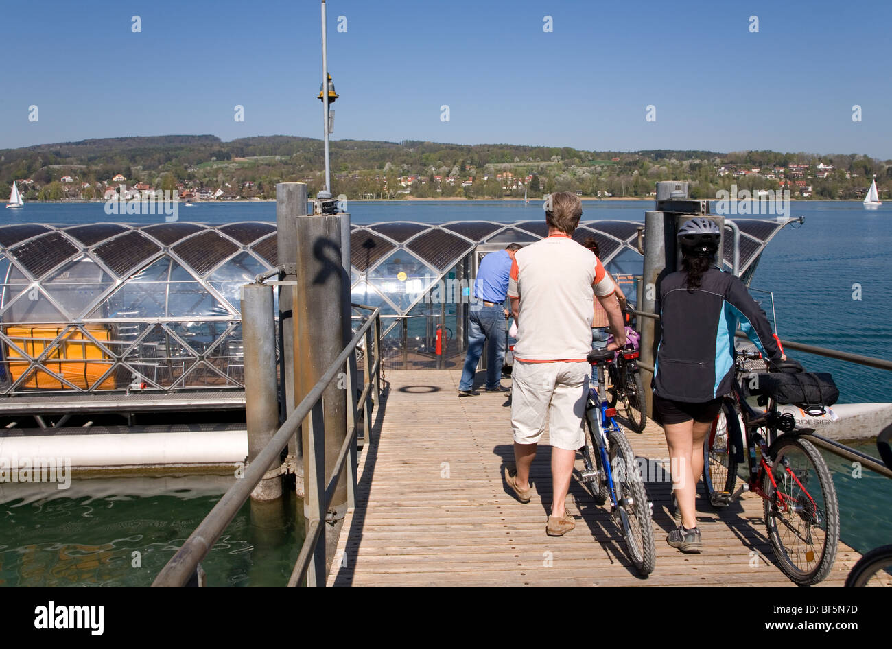 Solar Ferry to Gaienhofen, Shipping Pier, Bicyclists, Steckborn, Untersee, Lake Constance, Switzerland Stock Photo
