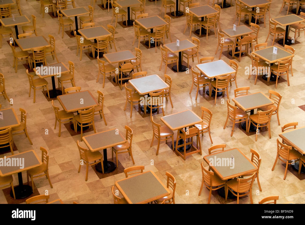 empty dining tables of fast food restaurants in a shopping center in
