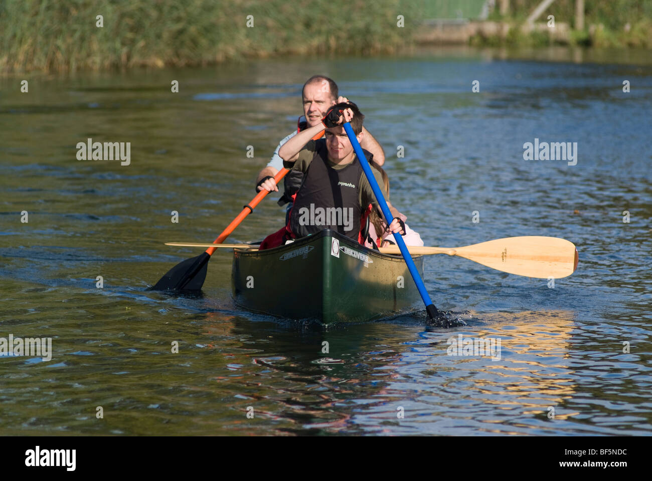 canoeists paddleing up river waveney on norfolk broads at geldeston Stock Photo