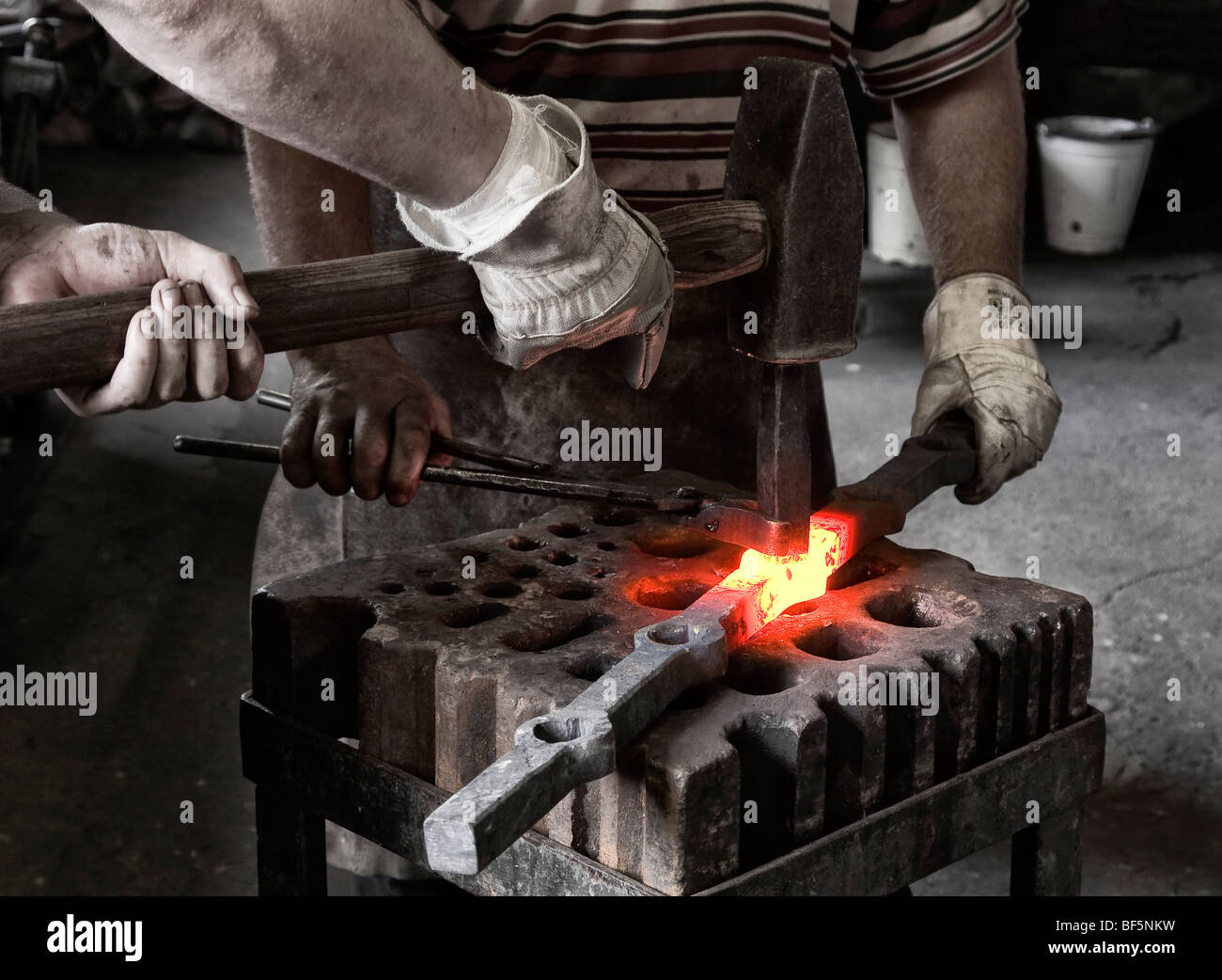 Blacksmith and his assistant at work, Berlin, Germany Stock Photo