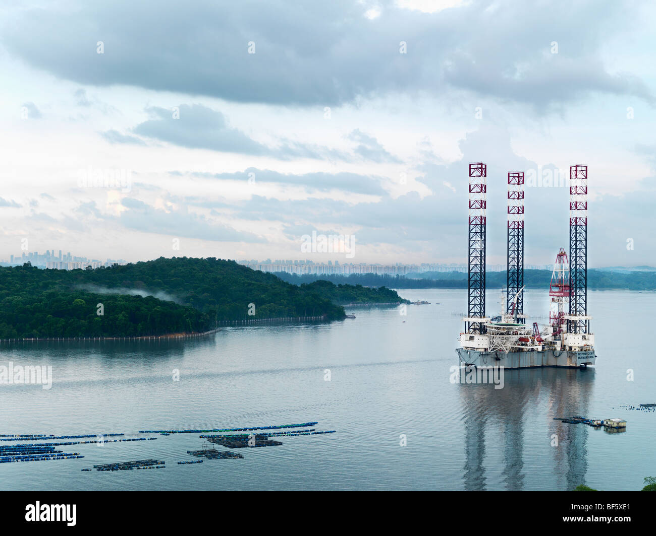 A scenic view of an oil rig located along side a fish farm off of Johor's coast. Stock Photo