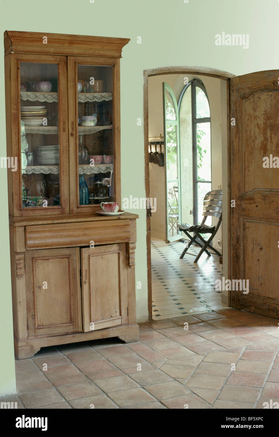 Antique Glass Front Dresser In French Country Hall With Terracotta